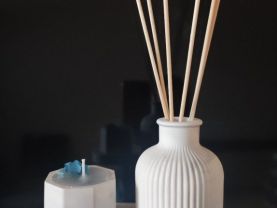 Decorative set of candles and vase on a stand