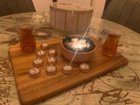 Handmade candle holder - tea candle in a natural clay pot, decorated inside with Mediterranean sea stones.